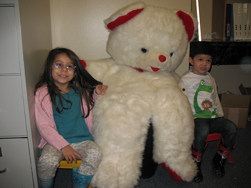 A brother and sister with the Christmas Teddy Bear